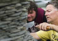 Man demonstrating schist wall to learner